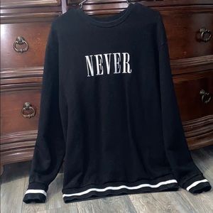Black sweater with the word “never” on it